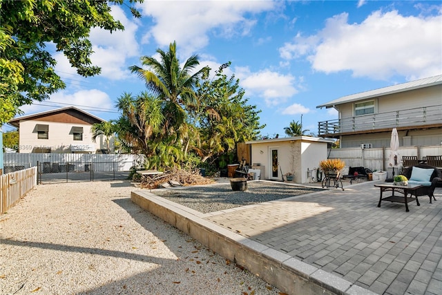 exterior space featuring a fenced backyard, an outbuilding, and a patio