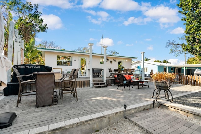 back of house featuring a patio area, an outdoor living space, and a deck