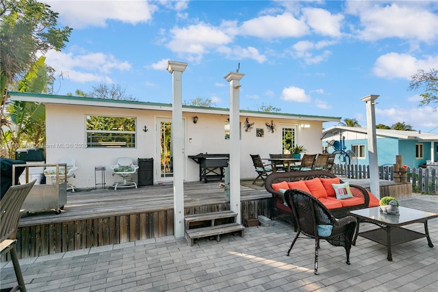 deck featuring fence, an outdoor hangout area, and outdoor dining space