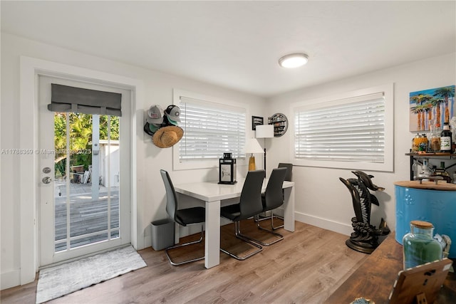 office space with plenty of natural light, light wood finished floors, and baseboards