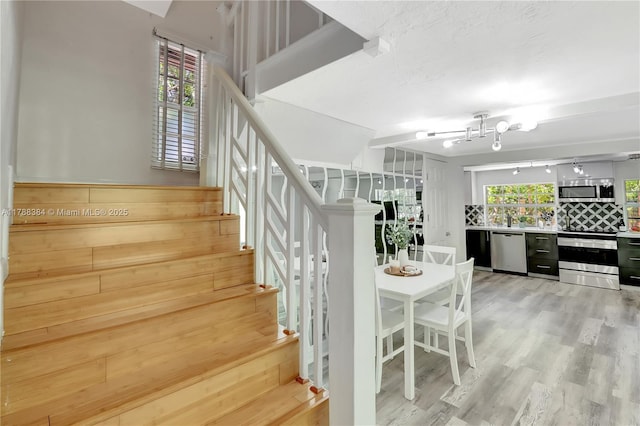3375 SW 29th Ter, Miami, FL 33133 - stairs featuring a chandelier and wood finished floors