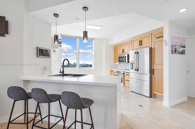 9751 E Bay Harbor Dr Unit 11D, Bay Harbor Islands, FL 33154 - kitchen featuring appliances with stainless steel finishes, a kitchen bar, a sink, light brown cabinets, and a peninsula