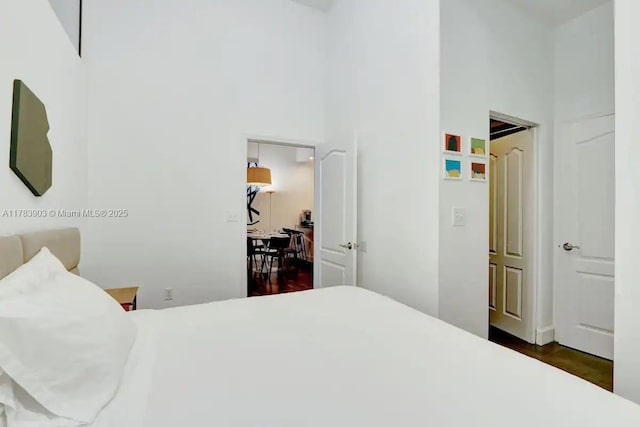 1200 Brickell Bay Dr Unit 1404, Miami, FL 33131 - bedroom featuring dark wood-type flooring and a high ceiling
