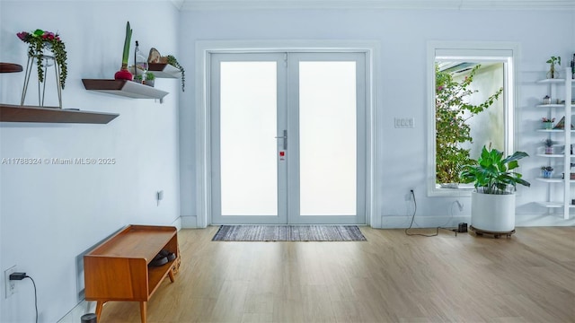 2105 Arch Creek Dr, North Miami, FL 33181 - doorway with french doors, wood finished floors, and baseboards