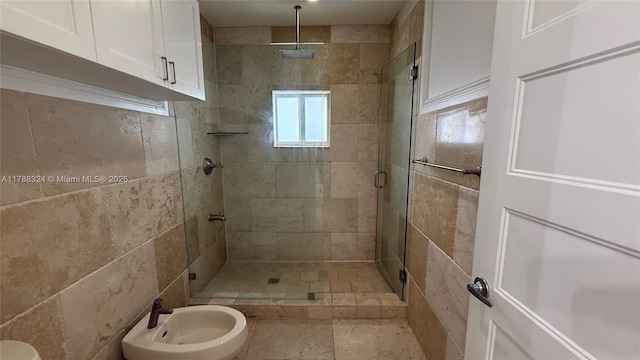 bathroom with a bidet and a shower stall