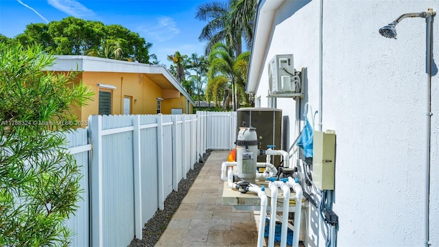 2105 Arch Creek Dr, North Miami, FL 33181 - view of property exterior featuring stucco siding, fence, and central air condition unit