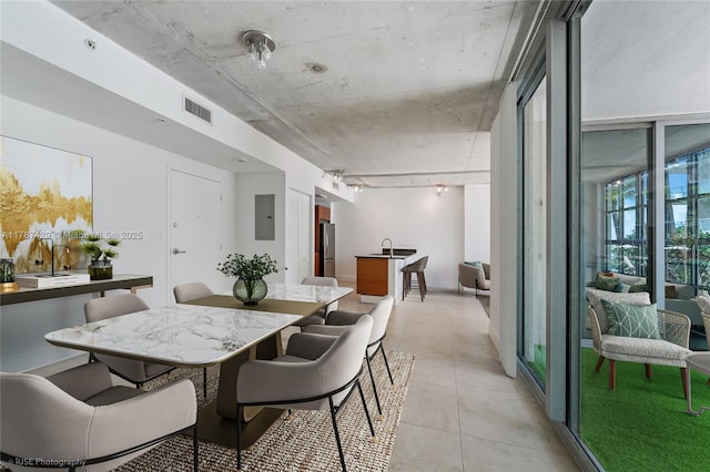 3451 NE 1st Ave Unit M0808, Miami, FL 33137 - kitchen with brown cabinetry, appliances with stainless steel finishes, dark stone countertops, and a sink
