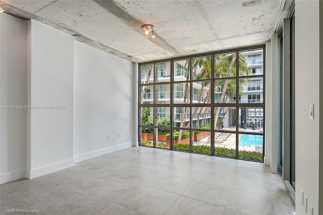 3451 NE 1st Ave Unit M0808, Miami, FL 33137 - spare room with baseboards, a healthy amount of sunlight, and a wall of windows
