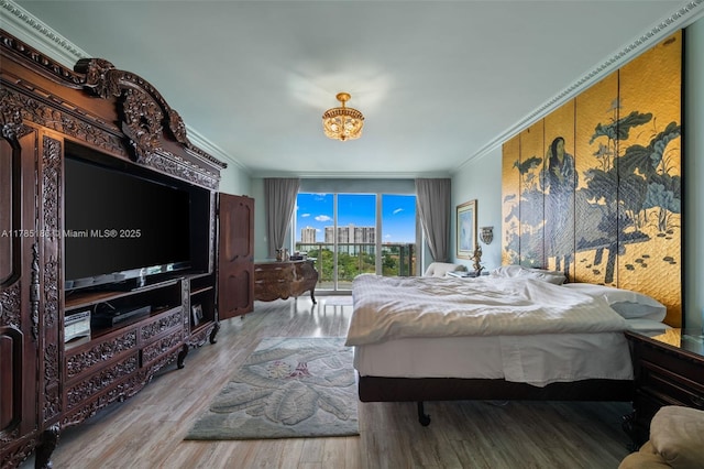 3201 NE 183rd St Unit 1107, Aventura, FL 33160 - bedroom featuring wood finished floors, ornamental molding, a chandelier, and access to exterior