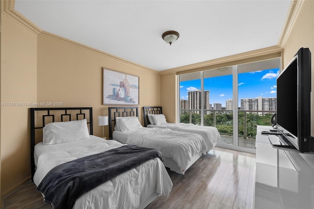 3201 NE 183rd St Unit 1107, Aventura, FL 33160 - bedroom featuring expansive windows, access to outside, wood finished floors, and crown molding
