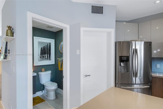 381 Franklin St, Hollywood, FL 33019 - bathroom featuring baseboards, visible vents, and toilet
