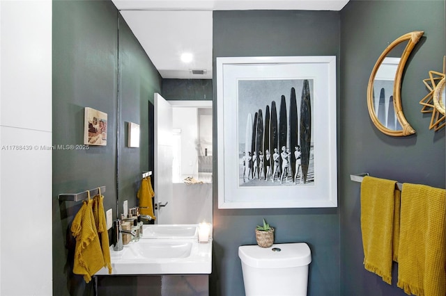 381 Franklin St, Hollywood, FL 33019 - bathroom with visible vents, toilet, and vanity