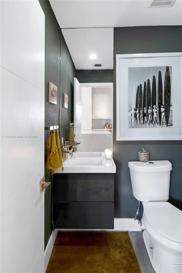 381 Franklin St, Hollywood, FL 33019 - bathroom with visible vents, vanity, and toilet
