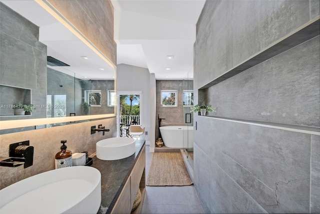 381 Franklin St, Hollywood, FL 33019 - bathroom with tile walls, a sink, a freestanding bath, and a stall shower