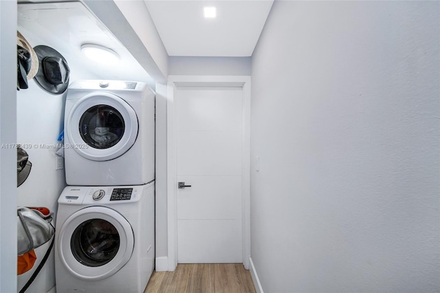 381 Franklin St, Hollywood, FL 33019 - laundry area with baseboards, stacked washer / dryer, laundry area, and light wood-type flooring