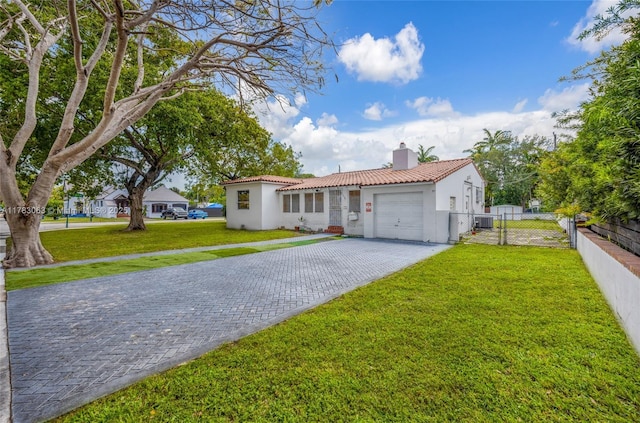 790 NE 96th St, Miami Shores, FL 33138 - mediterranean / spanish home featuring a garage, a tile roof, a chimney, and stucco siding