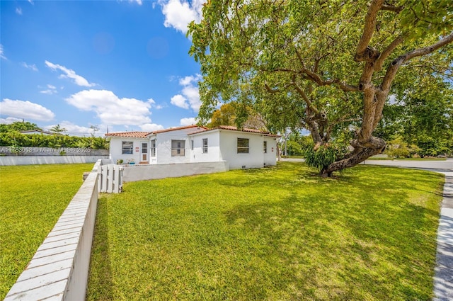 790 NE 96th St, Miami Shores, FL 33138 - back of property with fence, a tile roof, a yard, and stucco siding