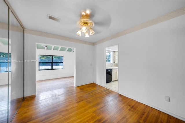 790 NE 96th St, Miami Shores, FL 33138 - unfurnished room featuring light wood-type flooring, a healthy amount of sunlight, ceiling fan, and visible vents
