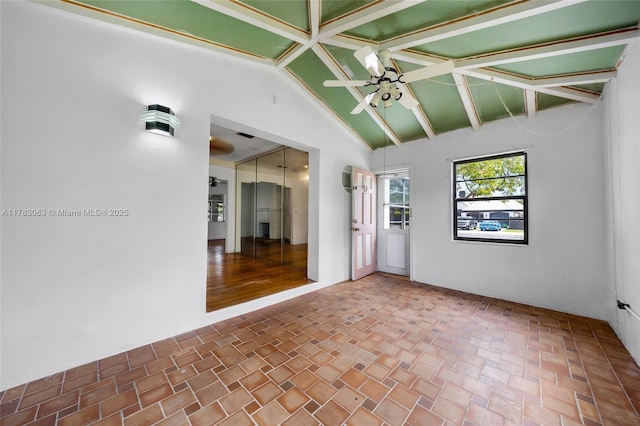 790 NE 96th St, Miami Shores, FL 33138 - empty room with lofted ceiling with beams, a ceiling fan, and brick patterned floor