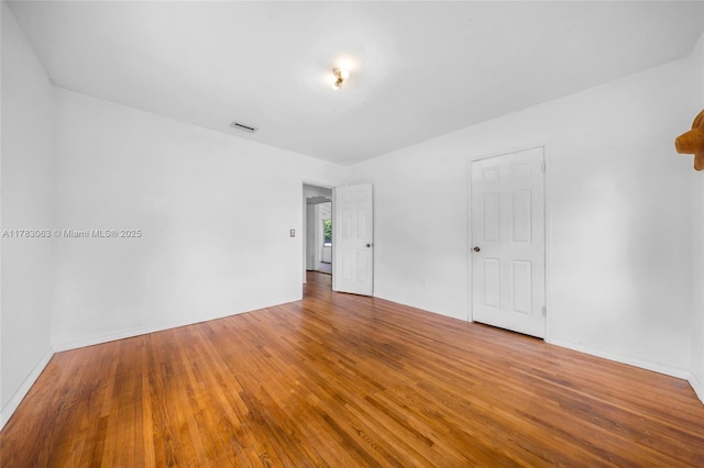 790 NE 96th St, Miami Shores, FL 33138 - unfurnished room with baseboards, hardwood / wood-style floors, and visible vents