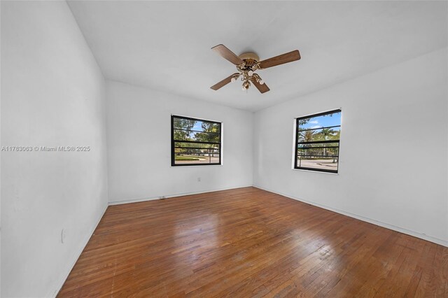 790 NE 96th St, Miami Shores, FL 33138 - empty room with wood finished floors, a wealth of natural light, and a ceiling fan