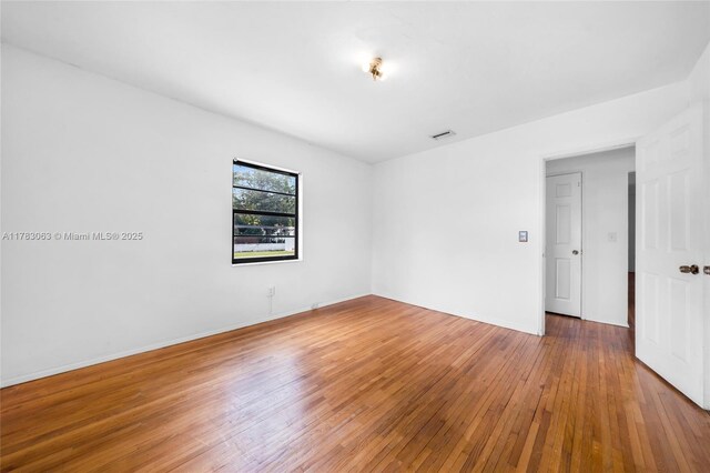 790 NE 96th St, Miami Shores, FL 33138 - empty room featuring baseboards, hardwood / wood-style floors, and visible vents