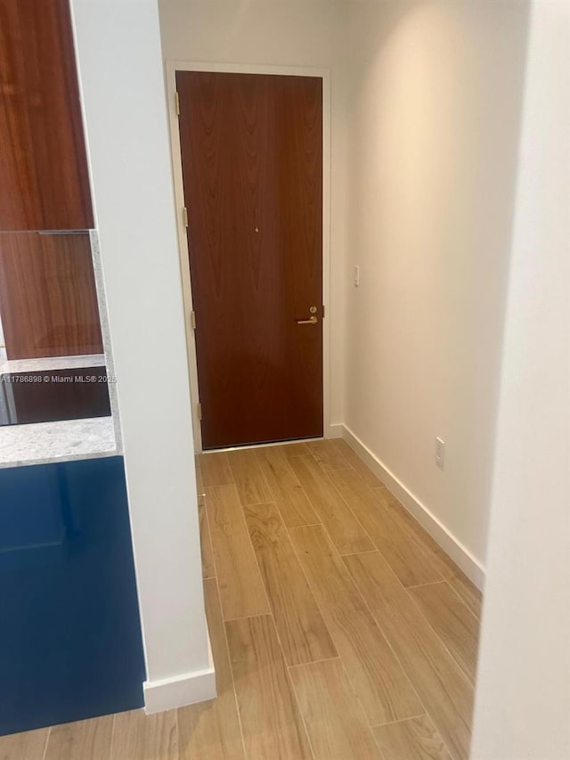 2655 S Bayshore Dr Unit 1607, Miami, FL 33133 - hallway featuring baseboards and light wood-style flooring