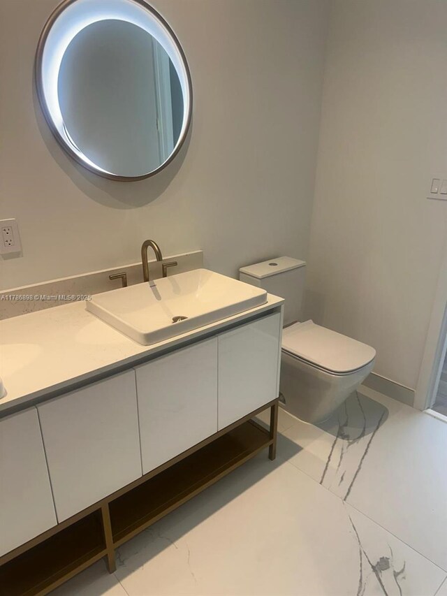 2655 S Bayshore Dr Unit 1607, Miami, FL 33133 - bathroom with a sink, toilet, double vanity, and marble finish floor