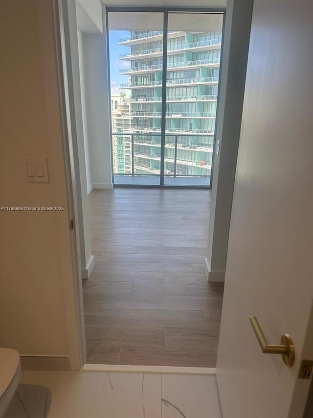 2655 S Bayshore Dr Unit 1607, Miami, FL 33133 - hall featuring baseboards and wood finished floors