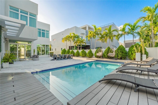 pool with fence and a patio area
