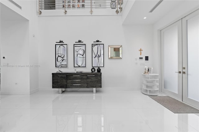 hallway with tile patterned floors and baseboards