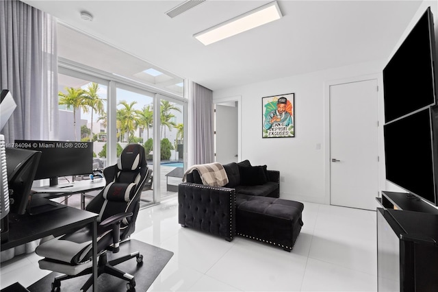 home office featuring a wall of windows, visible vents, and tile patterned floors