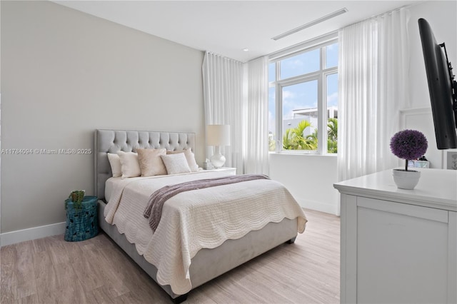 bedroom featuring light wood-type flooring and baseboards