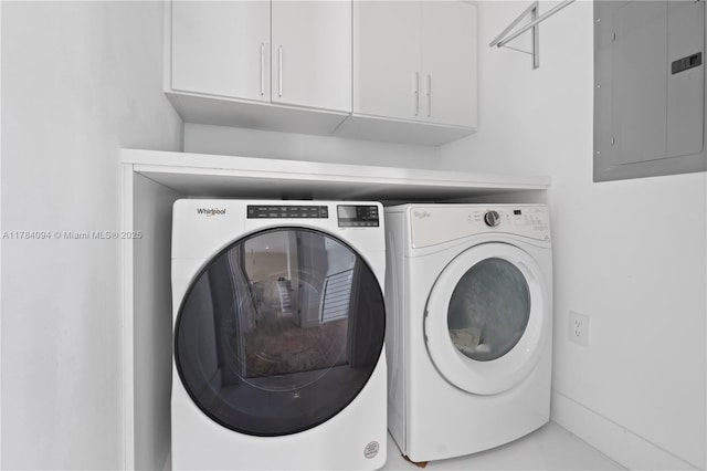 washroom featuring separate washer and dryer, electric panel, and cabinet space