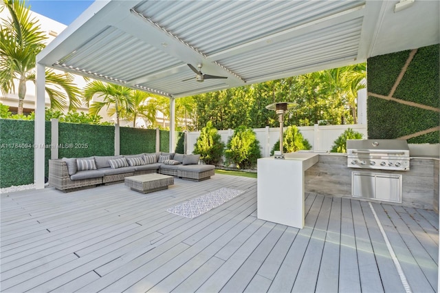 deck featuring an outdoor kitchen, a fenced backyard, outdoor lounge area, and area for grilling