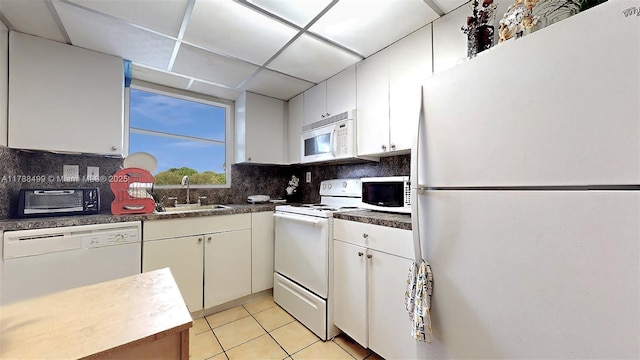 13715 Kendale Lakes Cir Unit Ph-A10, Miami, FL 33183 - kitchen featuring tasteful backsplash, a sink, white appliances, light tile patterned floors, and white cabinets