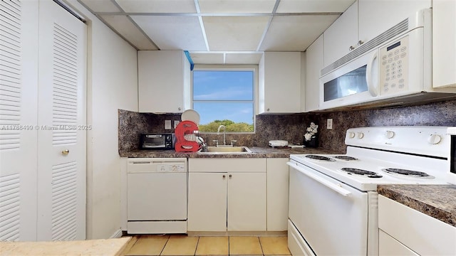 13715 Kendale Lakes Cir Unit Ph-A10, Miami, FL 33183 - kitchen with a sink, white appliances, light tile patterned floors, backsplash, and white cabinetry