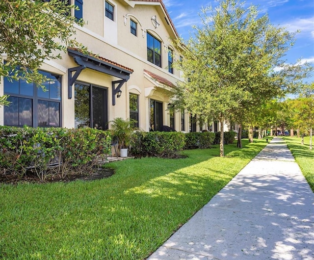 1047 NW 33rd Mnr, Pompano Beach, FL 33064 - view of home's exterior with stucco siding and a yard