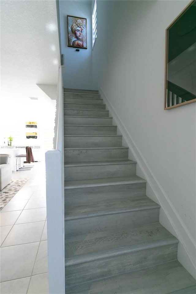stairway with tile patterned flooring