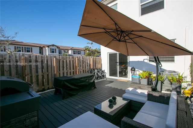 deck with fence, grilling area, an outdoor living space, and a residential view