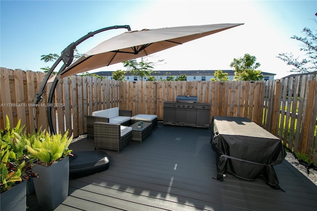wooden terrace featuring a fenced backyard