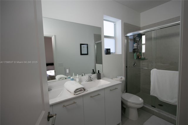 full bathroom with a shower stall, toilet, vanity, and ensuite bathroom