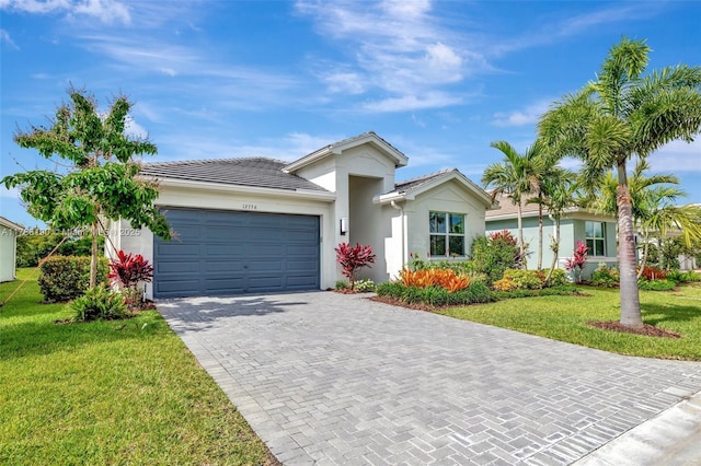 ranch-style house featuring stucco siding, a front yard, an attached garage, driveway, and a tile roof