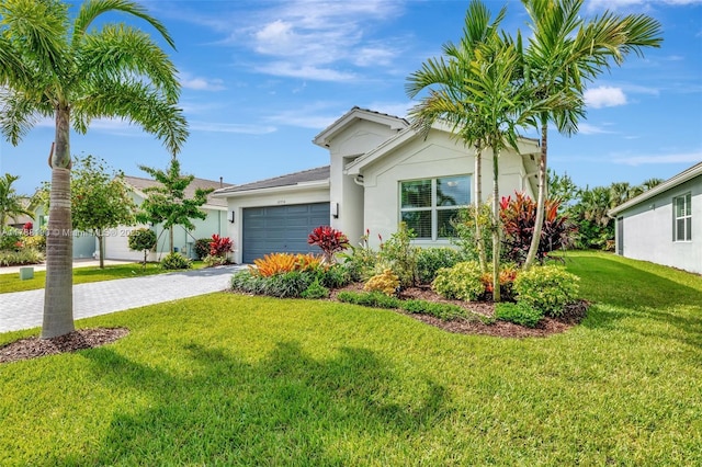 ranch-style house with decorative driveway, stucco siding, a garage, and a front yard