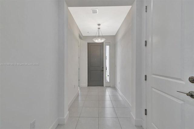 entryway featuring baseboards and light tile patterned floors