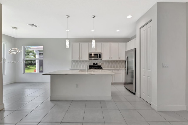 12756 SW Clear Water Way, Port St Lucie, FL 34987 - kitchen featuring stainless steel appliances, light countertops, decorative backsplash, white cabinetry, and light tile patterned floors