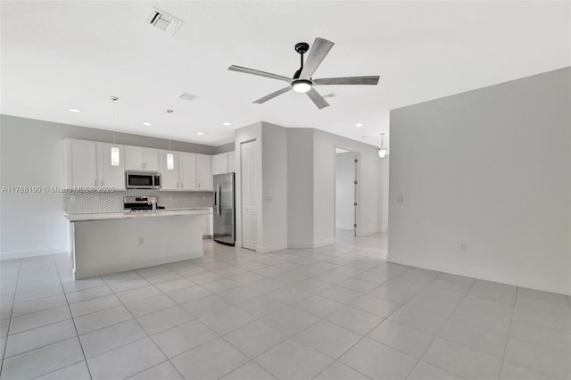 unfurnished living room featuring ceiling fan, baseboards, recessed lighting, and light tile patterned floors