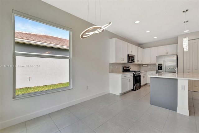 kitchen featuring appliances with stainless steel finishes, light countertops, backsplash, light tile patterned floors, and recessed lighting