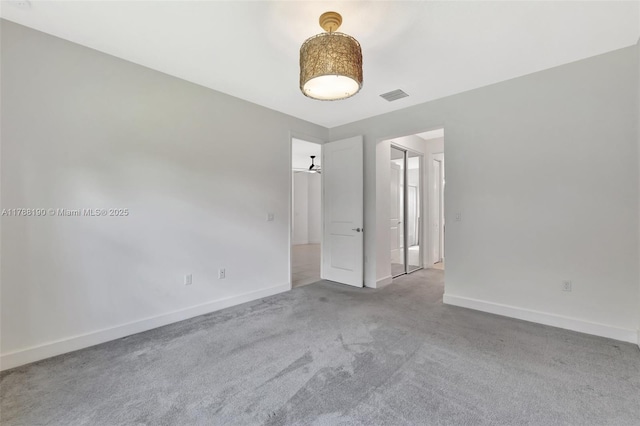 carpeted spare room with baseboards