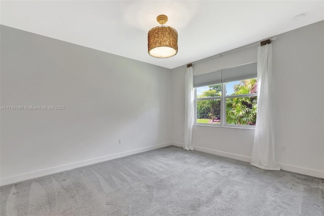 carpeted spare room with baseboards